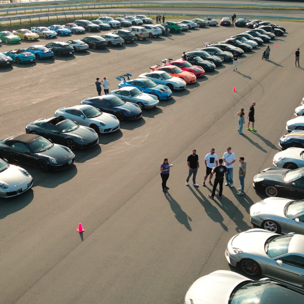 Drone view of fifty-plus Porsches on the track at the SickKids VS Charity Car Show, Porsche Experience Centre Toronto, Pickering, October 4, 2026